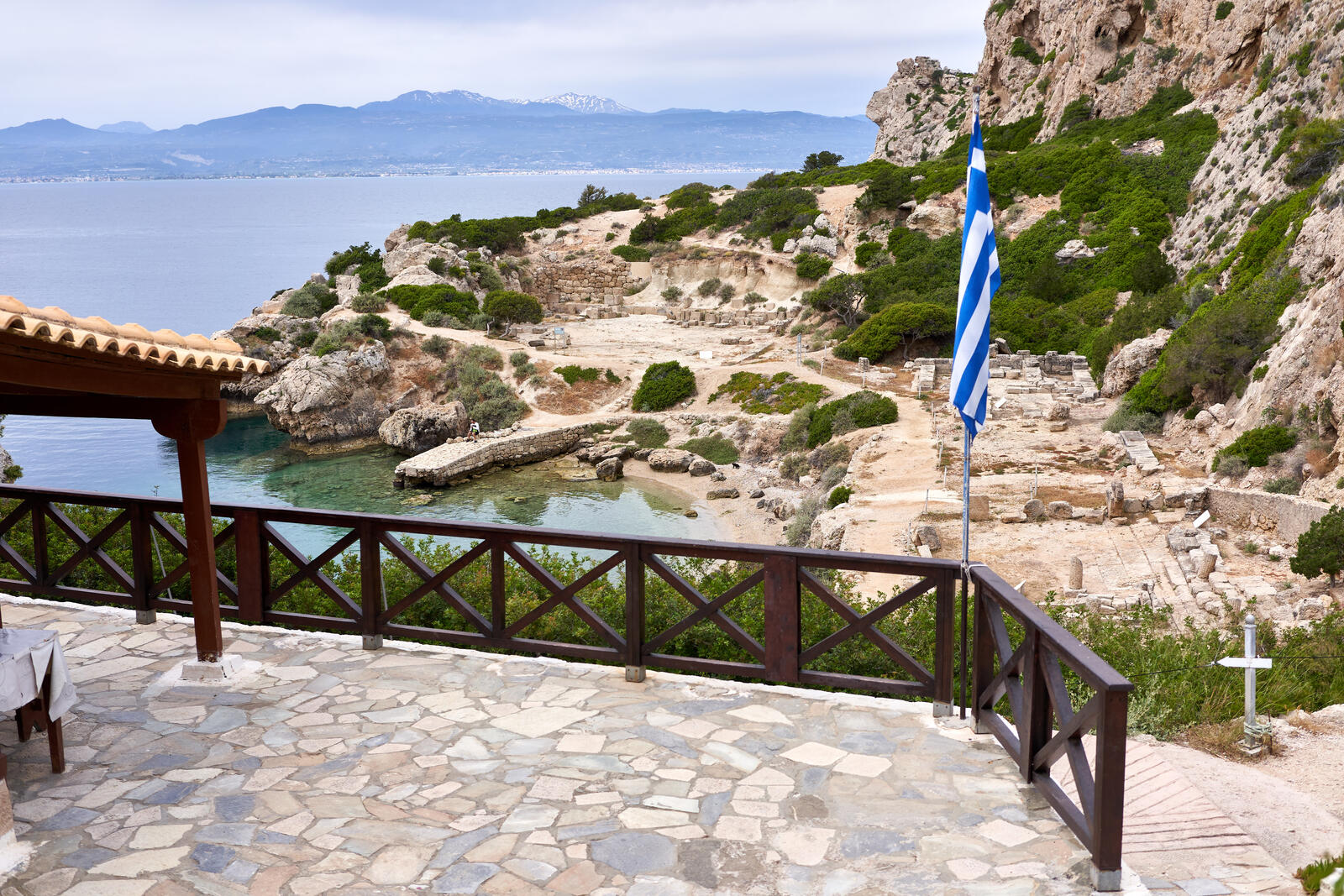 Stone ruins of the Heraion of Perachora sanctuary with the Gulf of Corinth in the background