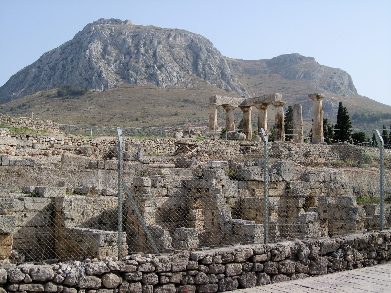 The hill of Acrocorinth rising behind the Temple of Apollo at Ancient Corinth